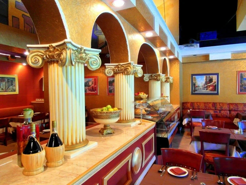Classical columns and arches in Vivaldi's warmly decorated dining room