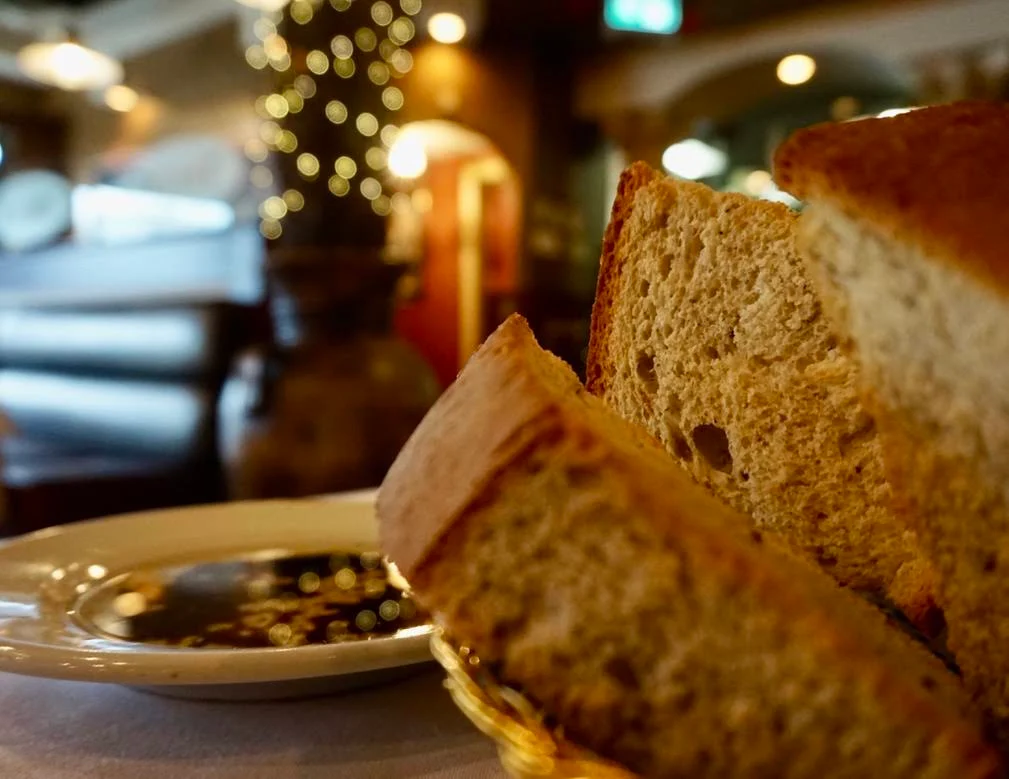 Fresh focaccia with a dish of balsamic and olive oil in our softly lit dining room