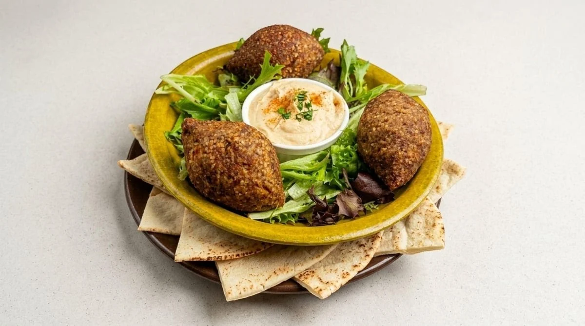 Kibbeh with creamy hummus, pita and fresh greens